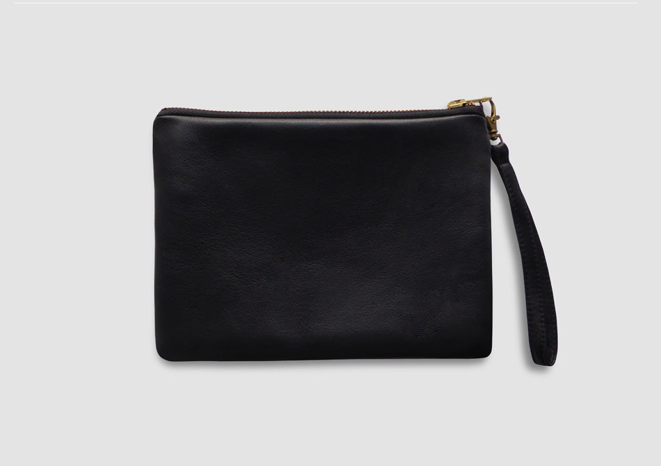 Black leather bag with wrist strap by Samantha Warren